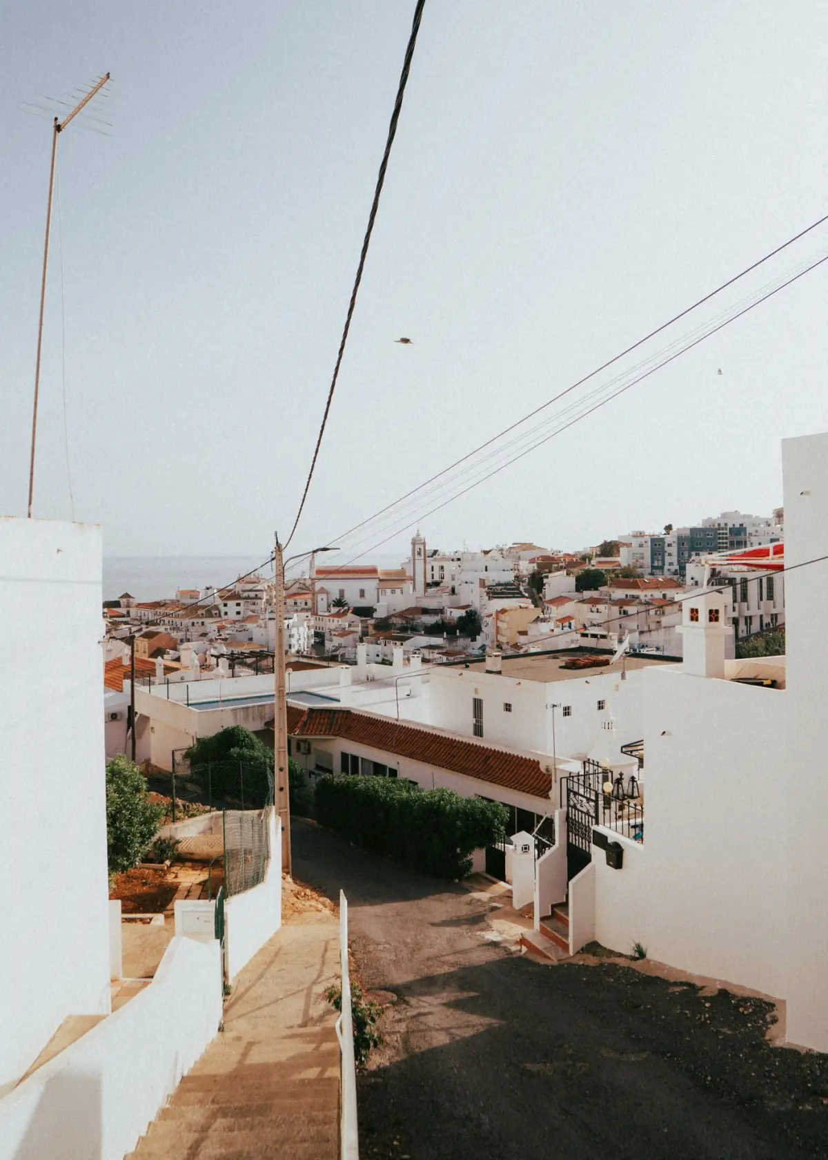 Arquitetura branca algarvia sobre a linha de costa, com casas de férias junto ao mar